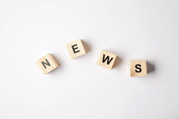 Top view of alphabet cubes making word news, on white background — Stock Photo