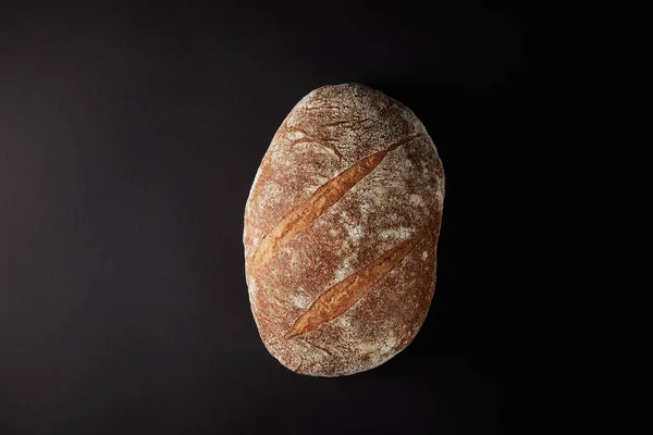 Elevated view of bread on dark rustic tabletop — Stock Photo