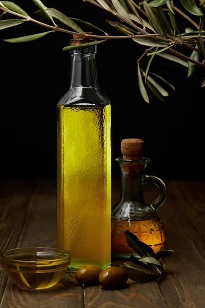 Botellas de aceite de oliva sobre mesa de madera - foto de stock
