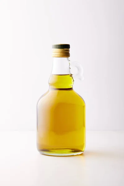 Bottle of extra virgin olive oil isolated on grey background — Stock Photo