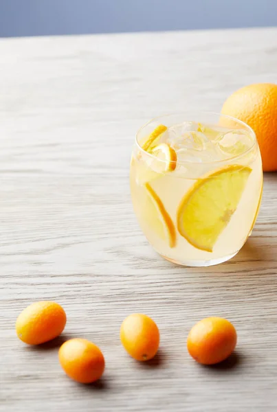 Close-up shot of orange lemonade on wooden surface — Stock Photo