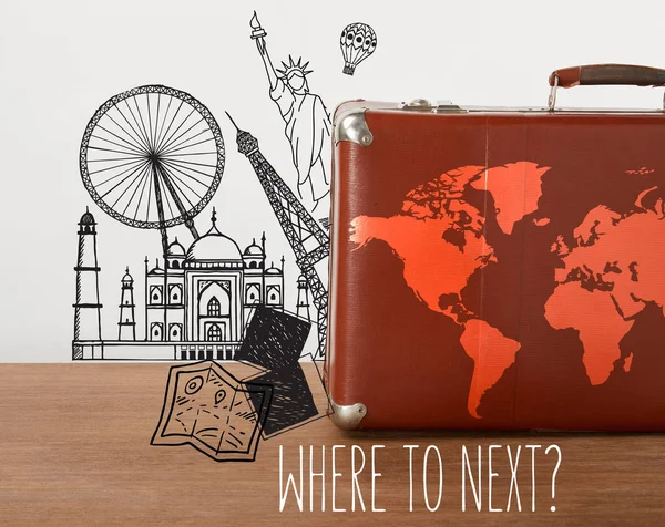Brown vintage suitcase with map and travel illustrations — Stock Photo