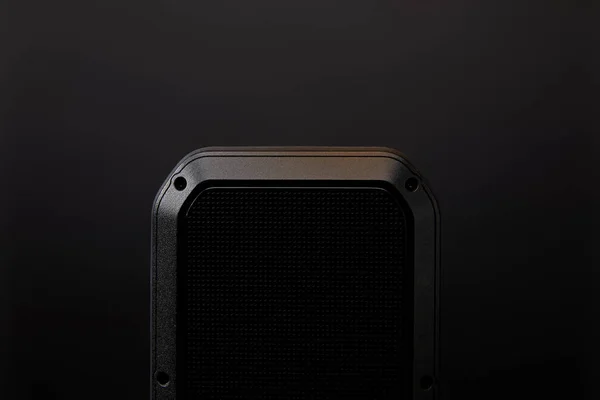 Close up view of black audio speaker on black wall backdrop — Stock Photo