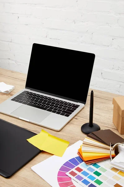 Vista de perto do laptop, tablet gráfico e palete na superfície de madeira no local de trabalho designer gráfico — Fotografia de Stock
