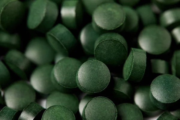 Full frame image of pile of spirulina pills background — Stock Photo