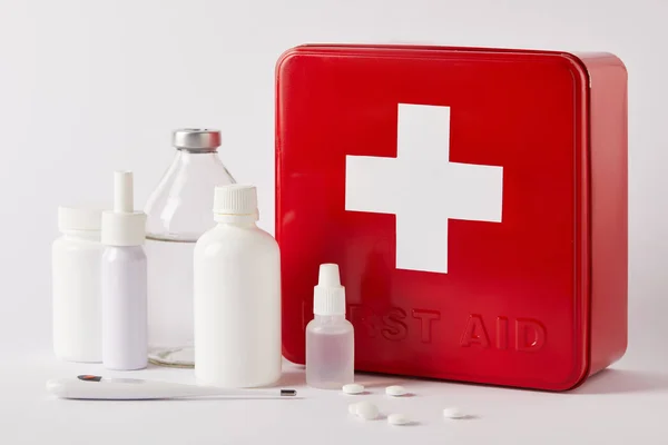 Close-up shot of first aid kit box with different medical supplies on white — Stock Photo