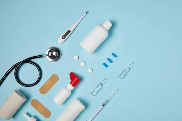 Top view of different medical supplies on blue surface — Stock Photo