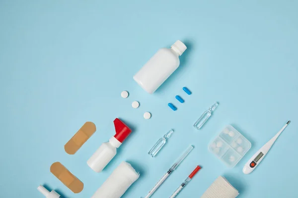 Top view of various medical supplies on blue surface — Stock Photo