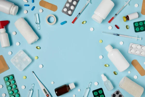 Top view of frame made of different medicines on blue surface — Stock Photo