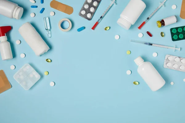 Top view of frame made of various medicines on blue surface — Stock Photo