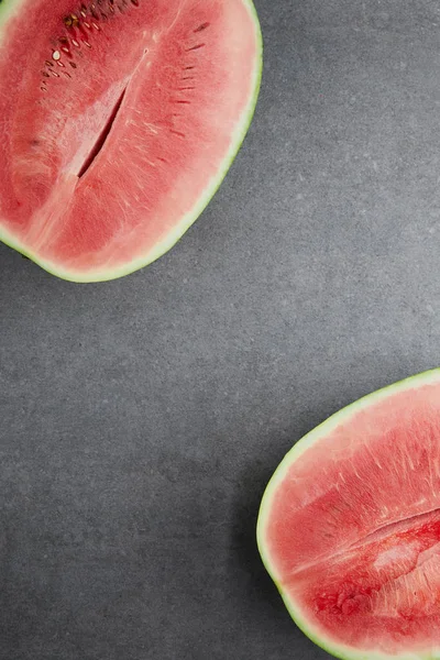 Top view of ripe watermelon pieces on grey concrete tabletop — Stock Photo