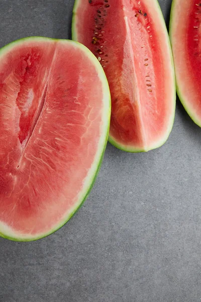 Flat lay with arranged watermelon pieces on grey concrete tabletop — Stock Photo