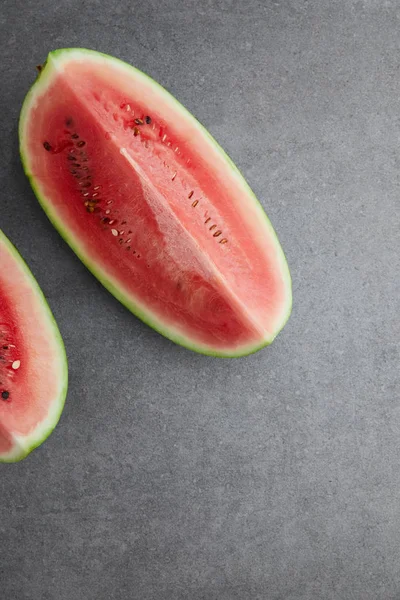 Flat lay with arranged watermelon pieces on grey concrete tabletop — Stock Photo