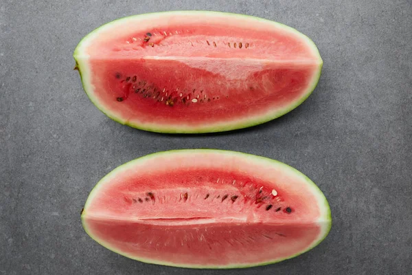 Flat lay with arranged watermelon pieces on grey concrete tabletop — Stock Photo