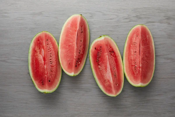 Top view of arranged fresh watermelon slices on grey wooden surface — Stock Photo