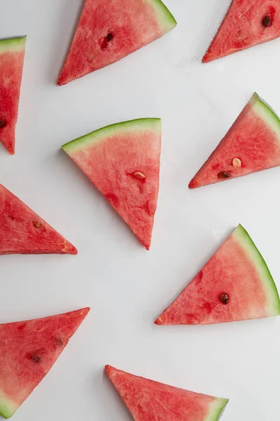 Food composition with ripe watermelon slices arranged on white surface — Stock Photo