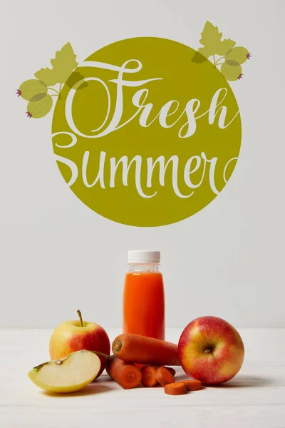 Bottle of detox smoothie with apples and carrots on white wooden surface, fresh summer inscription — Stock Photo