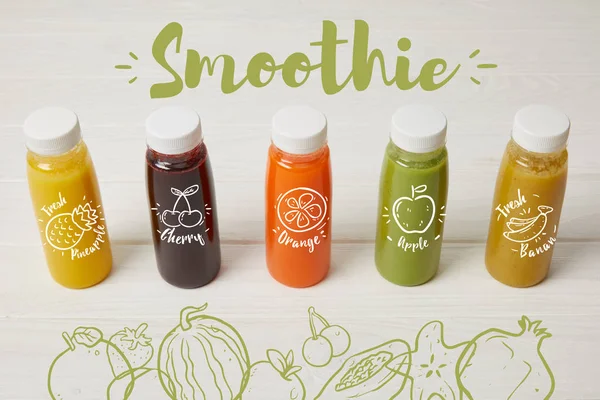 Fresh organic smoothies in bottles standing in row on white, smoothie inscription — Stock Photo