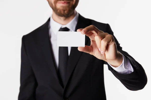 Partial view of businessman showing blank business card isolated on white background — Stock Photo