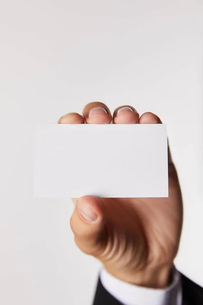 Cropped image of businessman showing empty business card isolated on white background — Stock Photo