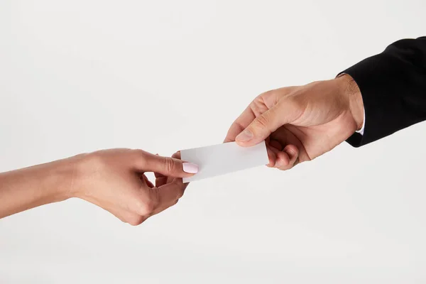 Cropped image of businessman giving visit card to businesswoman isolated on white background — Stock Photo