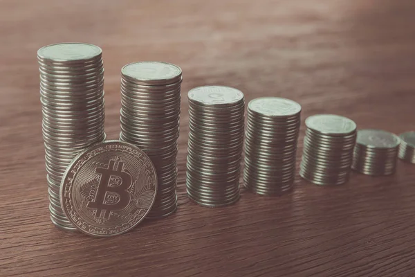 Bitcoin perto de pilhas de moedas em mesa, conceito de poupança — Fotografia de Stock