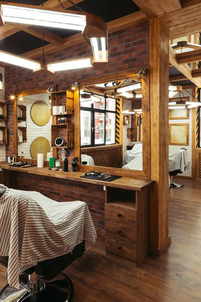 Stylish illuminated barbershop with modern interior — Stock Photo