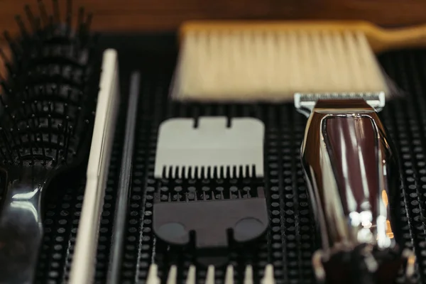 Close-up view of comb, brushes and electric clipper in barbershop — Stock Photo