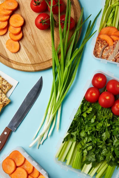 Flat lay with knife and healthy food composition isolated on blue — Stock Photo