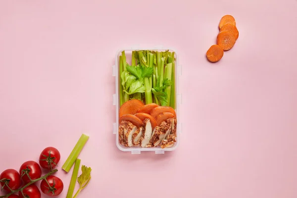 Flat lay with healthy food arranged in food container isolated on pink — Stock Photo