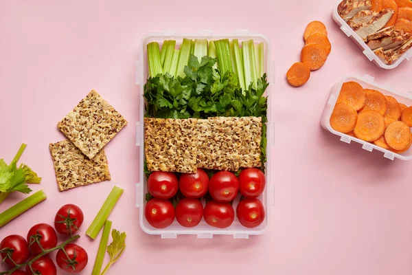 Flat lay with healthy food arranged in food containers isolated on pink — Stock Photo