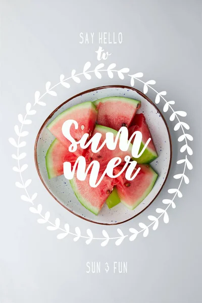 Top view of fresh watermelon pieces in bowl on white tabletop, with 