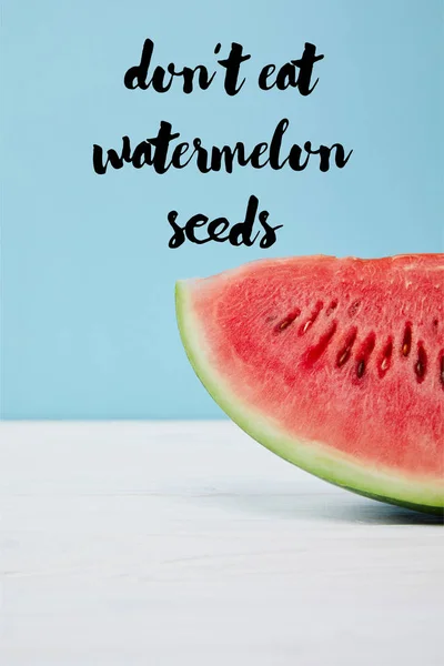 Süße frische Wassermelonenscheibe auf weißer Oberfläche auf blauem Hintergrund, mit dem Schriftzug 