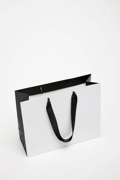 One open black and white shopping bag isolated on white — Stock Photo