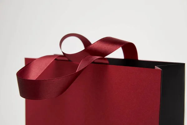 Selective focus of one burgundy shopping bag isolated on white — Stock Photo