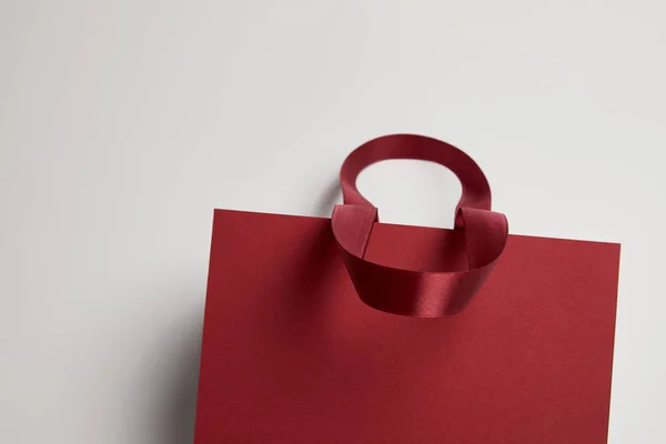 One burgundy paper shopping bag on white — Stock Photo