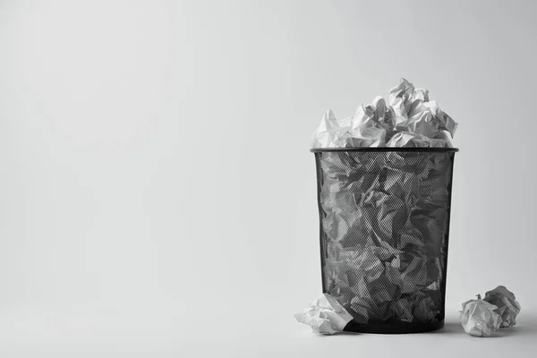 Офісний смітник зі збитим папером на білій поверхні — стокове фото