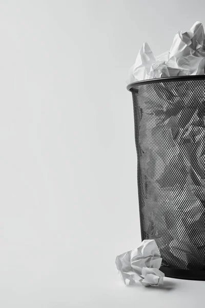 Close-up shot of office trash bin with crumpled papers on white — Stock Photo