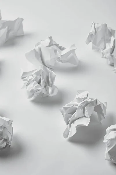 Close-up shot of spilled crumpled papers on white surface — Stock Photo