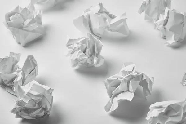 Close-up shot of messy crumpled papers on white surface — Stock Photo