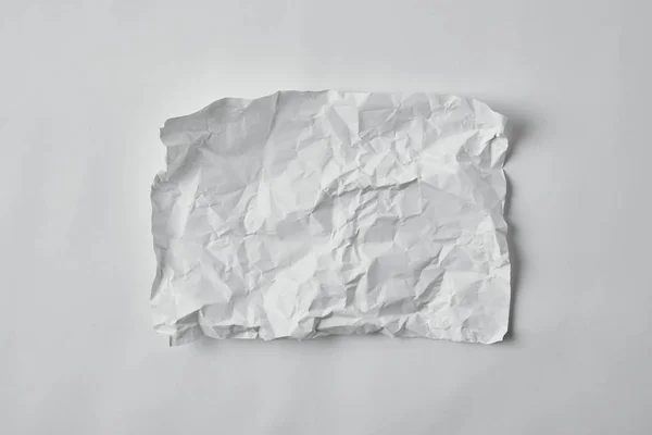 Top view of blank crumpled paper on white surface — Stock Photo