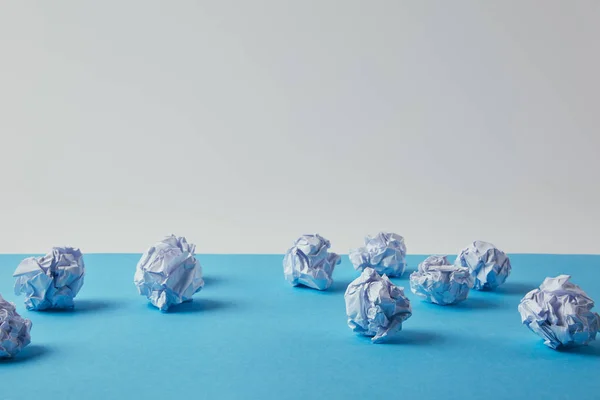 Close-up shot of crumpled papers on blue surface — Stock Photo