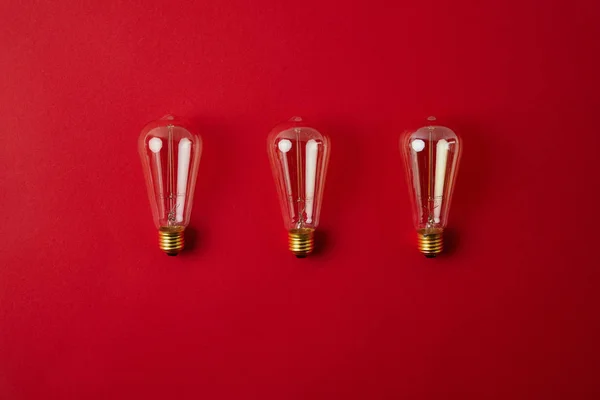 Top view of row of vintage incandescent lamps on red tabletop — Stock Photo