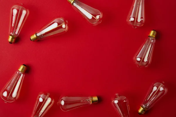 Top view of vintage incandescent lamps on red surface — Stock Photo