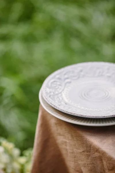 Two plates on table in garden — Stock Photo