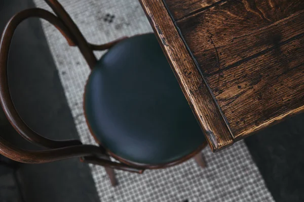 Vista de ángulo alto de la mesa de madera vintage y silla de pie en el restaurante - foto de stock