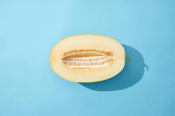 Top view of fresh ripe tasty melon on blue background — Stock Photo