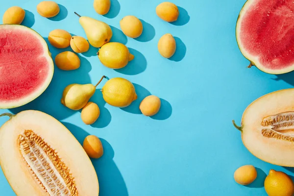 Top view of fresh ripe summer fruits on blue background — Stock Photo