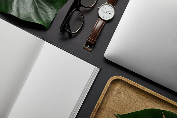 Modello flat lay con notebook aperto e laptop su sfondo nero — Foto stock