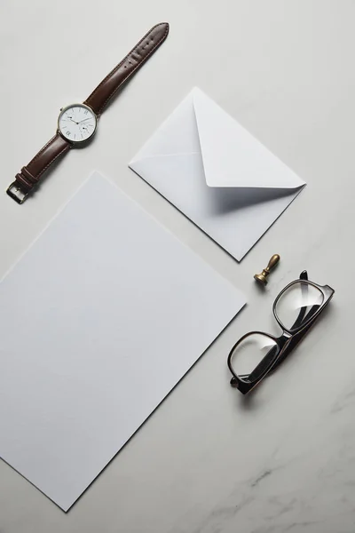 Business mock up set with glasses and watch on white marble background — Stock Photo